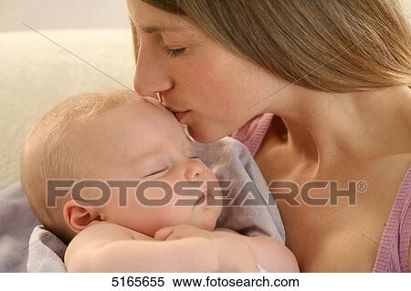 Mother kissing sleeping baby View Large Photo Image Stock Photography - Mother kissing sleeping baby . Fotosearch