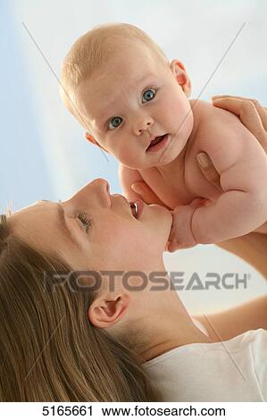 Mother lifting up baby View Large Photo Image Stock Image - Mother lifting up baby . Fotosearch