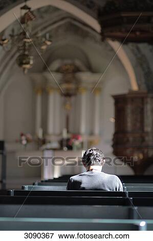 One person sitting in church, Flensburg, Schleswig-Holstein, Germany View Large Photo Image Stock Photo - One person sitting in church, Flensburg, Schleswig-Holstein, Germany . Fotosearch