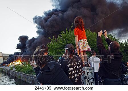 People looking at burning paper mill, Kreuzberg, Berlin, Germany View Large Photo Image Stock Image - People looking at burning paper mill, Kreuzberg, Berlin, Germany . Fotosearch