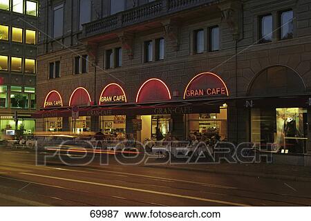 People sitting at sidewalk cafe during night, Zurich, Switzerland View Large Photo Image Stock Photo - People sitting at sidewalk cafe during night, Zurich, Switzerland . Fotosearch