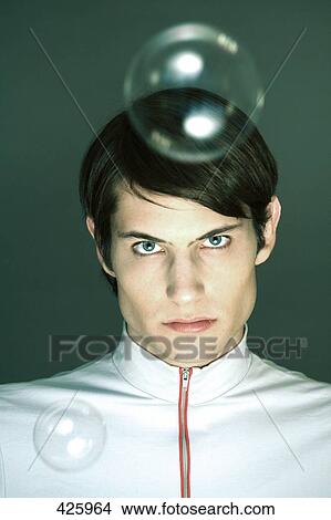 Picture - Portrait of young man looking serious . Fotosearch