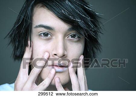 Stock Image - Portrait of young man looking serious . Fotosearch