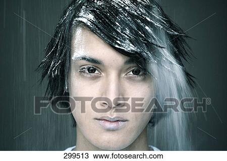 Stock Image - Portrait of young man looking serious . Fotosearch
