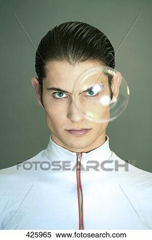 Portrait of young man looking serious View Large Photo Image Stock Photography - Portrait of young man looking serious . Fotosearch