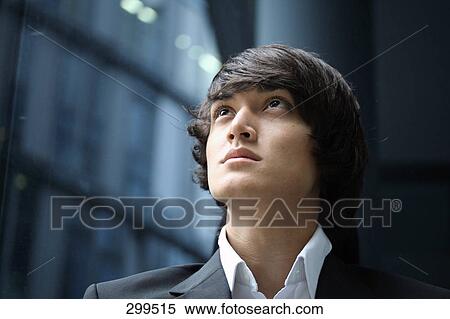 Portrait of young man looking upward View Large Photo Image Stock Photography - Portrait of young man looking upward . Fotosearch