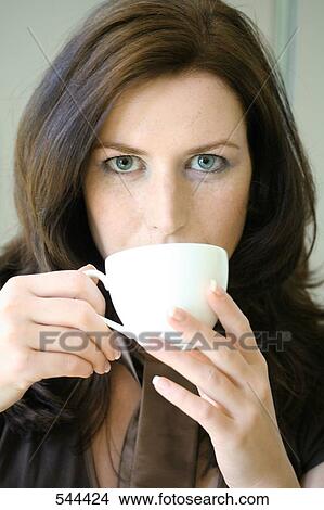 Portrait of young woman drinking coffee View Large Photo Image Picture - Portrait of young woman drinking coffee . Fotosearch