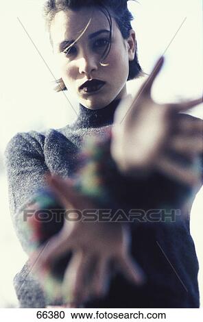 Stock Image - Portrait of young woman gesturing and looking serious . Fotosearch