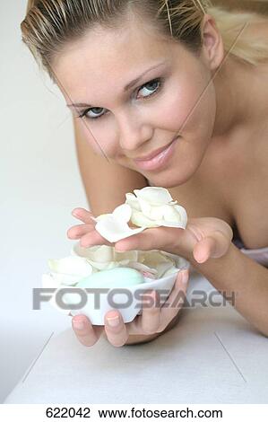 Portrait of young woman holding bowl of flower petals and smiling View Large Photo Image Stock Image - Portrait of young woman holding bowl of flower petals and smiling . Fotosearch