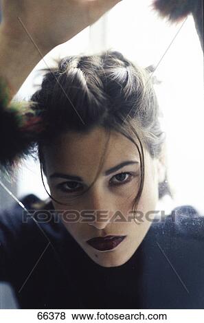 Stock Photo - Portrait of young woman looking serious . Fotosearch