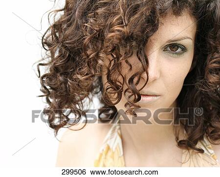 Stock Photograph - Portrait of young woman looking serious . Fotosearch
