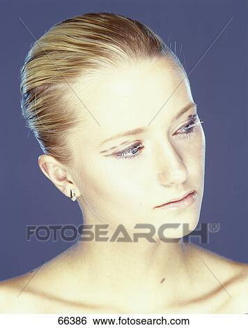 Stock Photograph - Portrait of young woman looking sceptical . Fotosearch