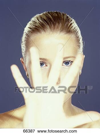Stock Photo - Portrait of young woman making stop gesture . Fotosearch