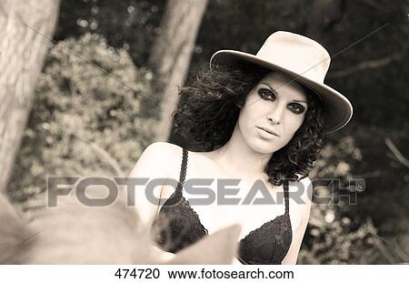 Stock Image - Portrait of young woman riding horse . Fotosearch