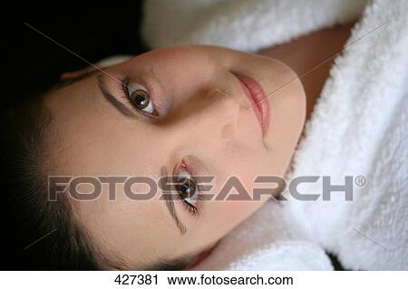 Stock Image - Portrait of young woman smiling . Fotosearch