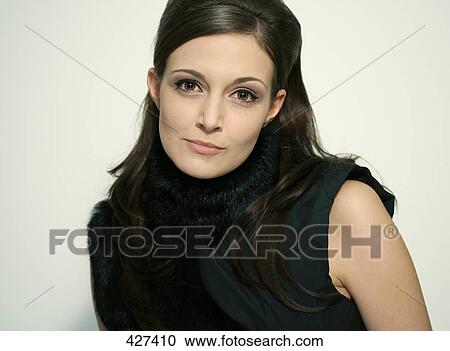 Stock Image - Portrait of young woman smiling . Fotosearch