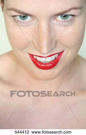 Stock Image - Portrait of young woman smiling . Fotosearch