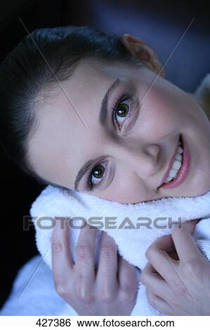 Stock Photograph - Portrait of young woman smiling . Fotosearch