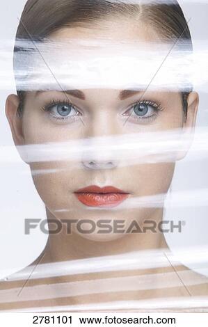 Stock Image - Portrait of young woman undergoing plastic surgery . Fotosearch