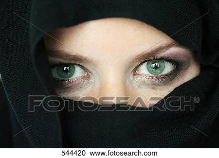 Stock Image - Portrait of young woman wearing a burqa . Fotosearch