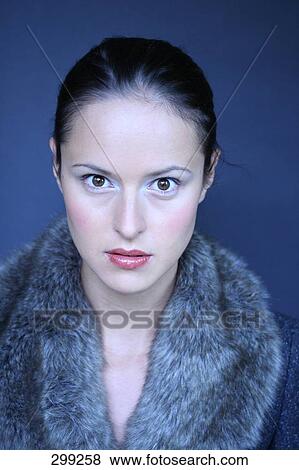 Portrait of young woman wearing fur coat View Large Photo Image Stock Photo - Portrait of young woman wearing fur coat . Fotosearch