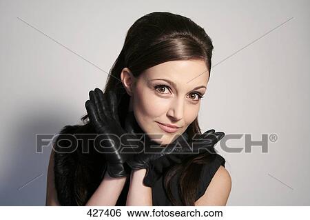 Portrait of young woman wearing leather gloves View Large Photo Image Stock Photograph - Portrait of young woman wearing leather gloves . Fotosearch