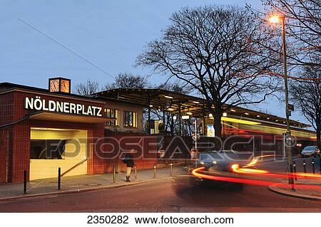Stock Image - Railway station lit up at dusk, Noeldnerplatz, Berlin, Germany . Fotosearch