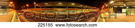 Railway station platform lit up at night View Large Photo Image Stock Photography - Railway station platform lit up at night . Fotosearch