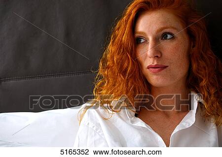 Stock Image - Redheaded woman looking sideways . Fotosearch