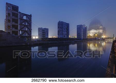Stock Image - Reflection of buildings in water, Spree River, Palast Der Republik, Berlin, Germany . Fotosearch