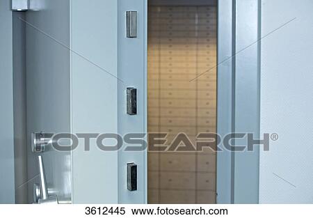 Safe deposit boxes behind vault door View Large Photo Image Stock Photography - Safe deposit boxes behind vault door . Fotosearch