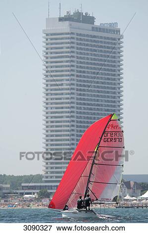 Stock Photo - Sailing ship on baltic sea, Hotel Maritim in the background, Schleswig-Holstein, Germany . Fotosearch