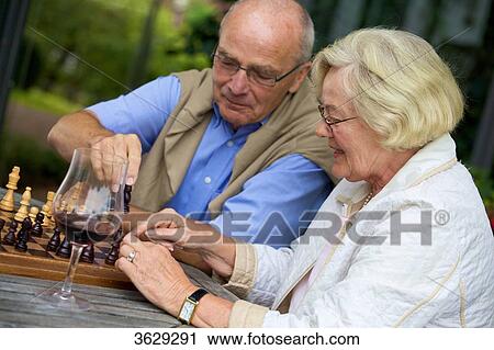 Senior couple on terrace playing chess View Large Photo Image Stock Image - Senior couple on terrace playing chess . Fotosearch