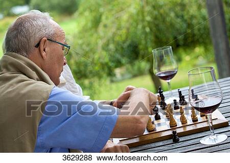 Senior couple on terrace playing chess View Large Photo Image Stock Photo - Senior couple on terrace playing chess . Fotosearch