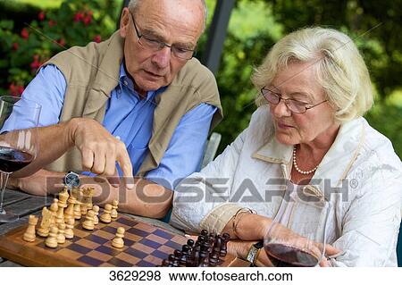 Senior couple on terrace playing chess View Large Photo Image Stock Photo - Senior couple on terrace playing chess . Fotosearch