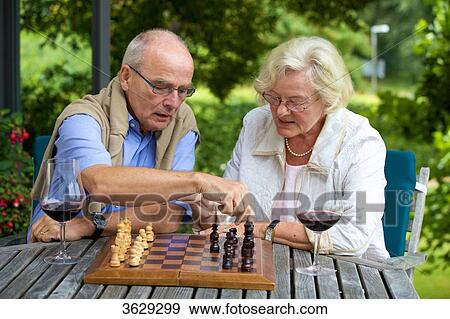 Senior couple on terrace playing chess View Large Photo Image Stock Photo - Senior couple on terrace playing chess . Fotosearch