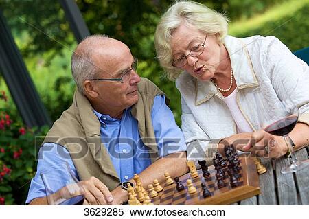 Senior couple on terrace playing chess View Large Photo Image Stock Photography - Senior couple on terrace playing chess . Fotosearch
