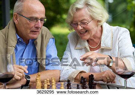 Senior couple on terrace playing chess View Large Photo Image Stock Photography - Senior couple on terrace playing chess . Fotosearch