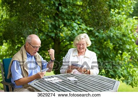 Senior couple playing cards on the terrace View Large Photo Image Picture - Senior couple playing cards on the terrace . Fotosearch