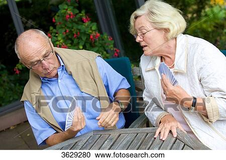 Senior couple playing cards on the terrace View Large Photo Image Stock Image - Senior couple playing cards on the terrace . Fotosearch