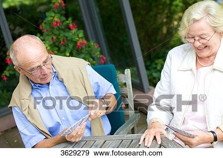 Senior couple playing cards on the terrace View Large Photo Image Stock Photo - Senior couple playing cards on the terrace . Fotosearch