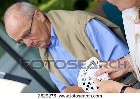 Senior couple playing cards on the terrace View Large Photo Image Stock Photograph - Senior couple playing cards on the terrace . Fotosearch