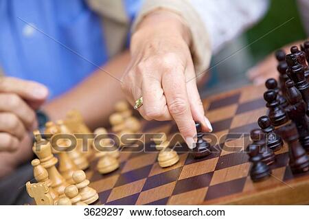 Senior couple playing chess, close-up View Large Photo Image Stock Photo - Senior couple playing chess, close-up . Fotosearch