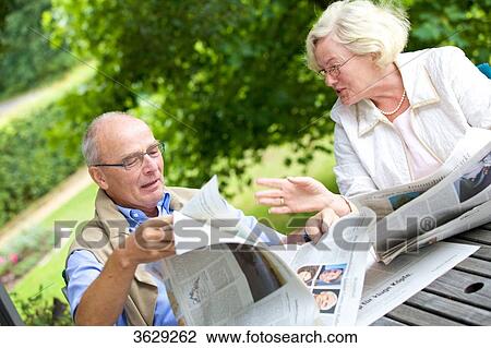 Senior couple reading newspaper on the terrace View Large Photo Image Stock Image - Senior couple reading newspaper on the terrace . Fotosearch