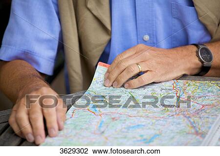 Senior man looking in road map, close-up View Large Photo Image Stock Image - Senior man looking in road map, close-up . Fotosearch