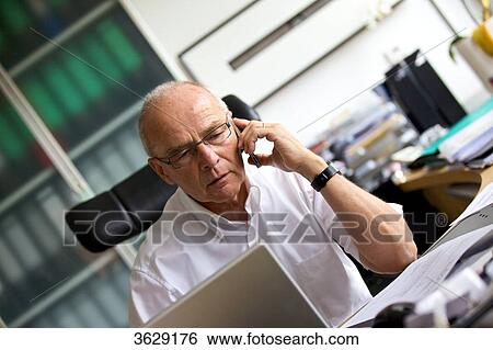 Senior man on cell phone in home office View Large Photo Image Stock Photograph - Senior man on cell phone in home office . Fotosearch