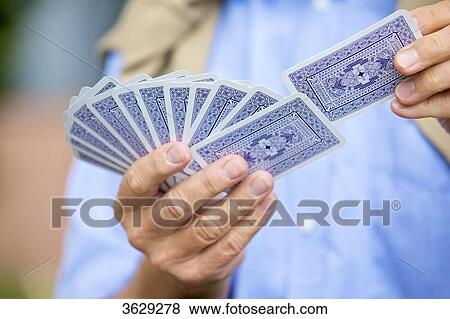 Senior man playing cards, close-up View Large Photo Image Stock Photo - Senior man playing cards, close-up . Fotosearch