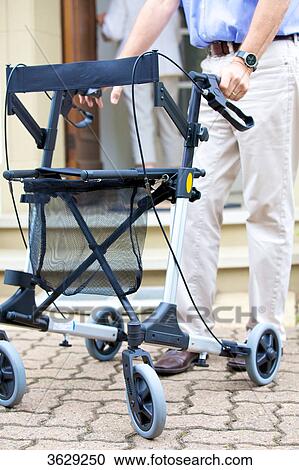 Senior man walking with walking frame View Large Photo Image Stock Image - Senior man walking with walking frame . Fotosearch