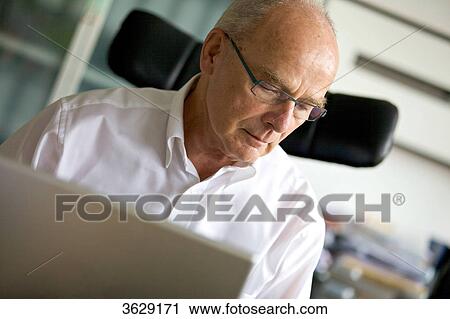 Senior man with laptop in home office View Large Photo Image Stock Image - Senior man with laptop in home office . Fotosearch