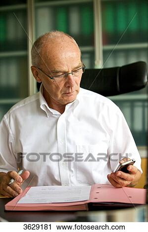 Senior man working in home office View Large Photo Image Stock Image - Senior man working in home office . Fotosearch